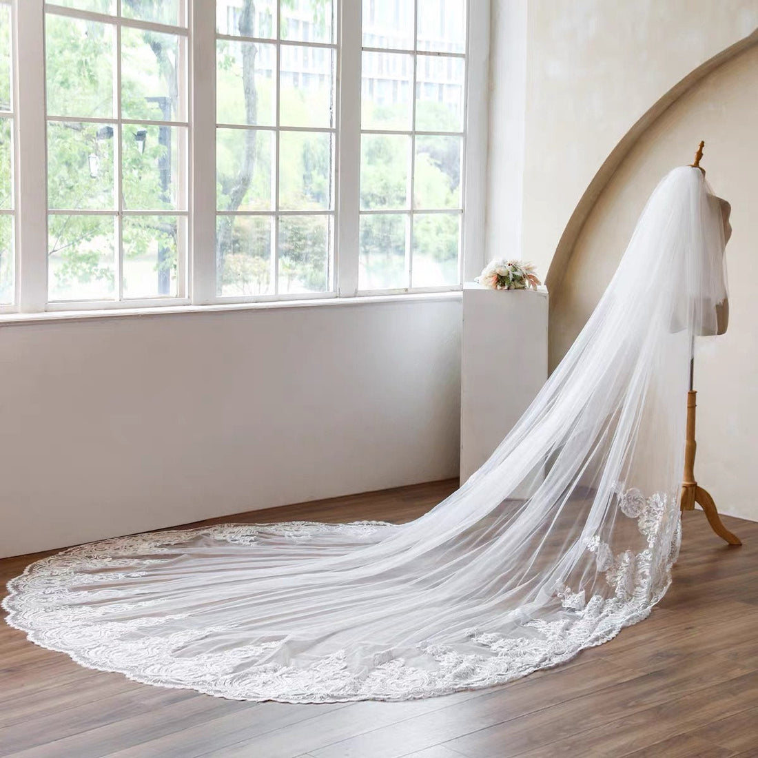 Bride wearing a long cathedral wedding veil with an elegant wedding dress