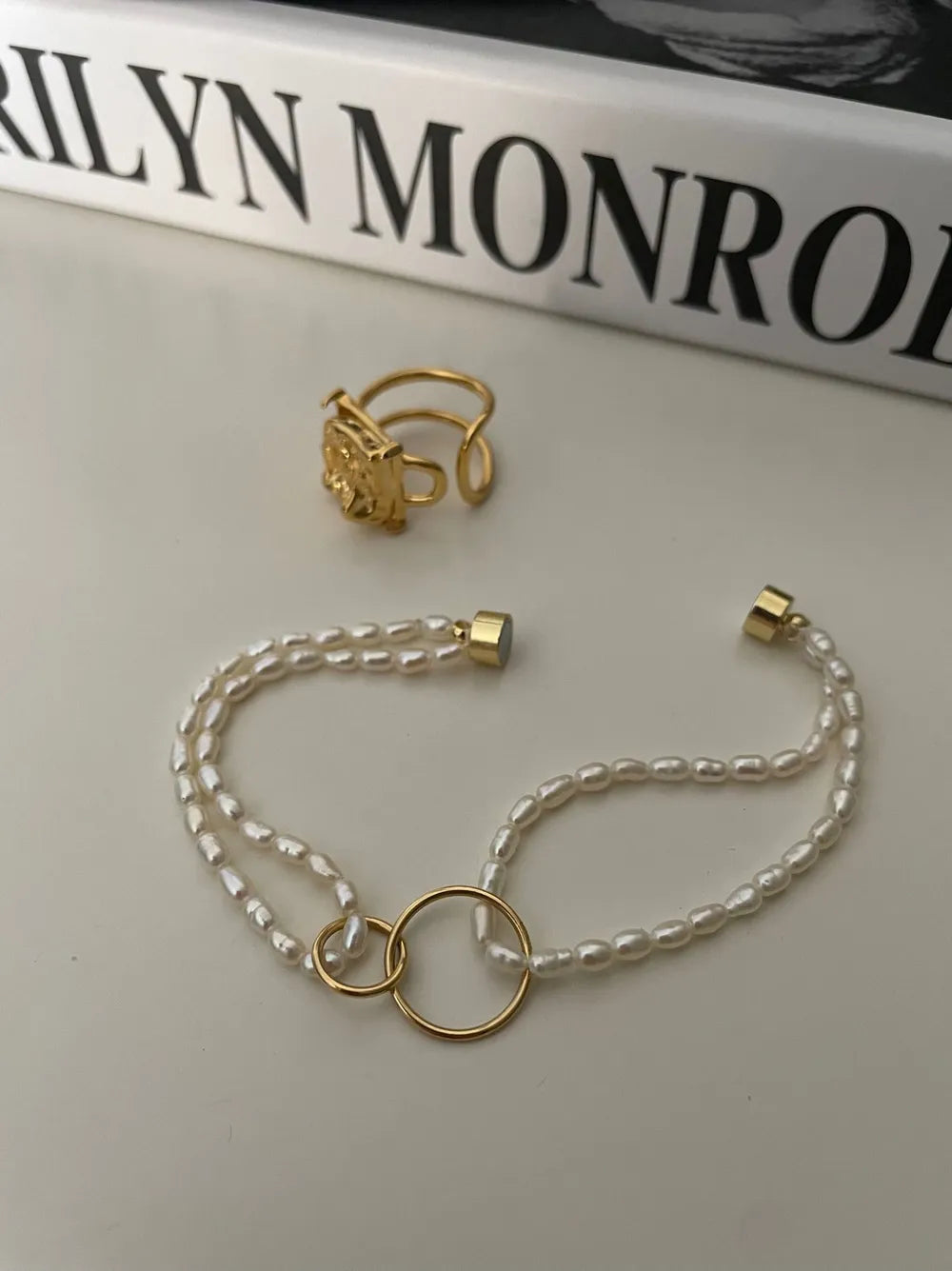 Opened view of the 14k gold-filled magnetic clasp on the double-strand seed pearl chain.