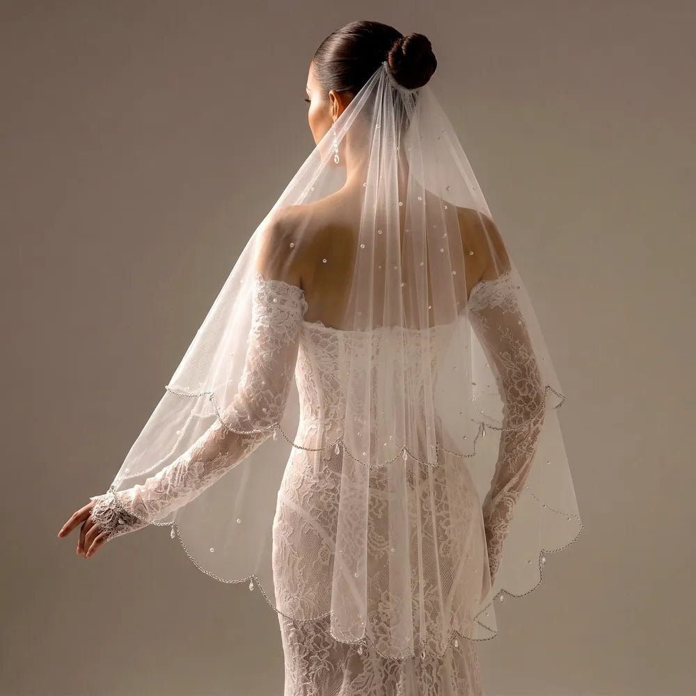 Close-up of overlapping tulle tiers demonstrating romantic depth created by double scalloped borders