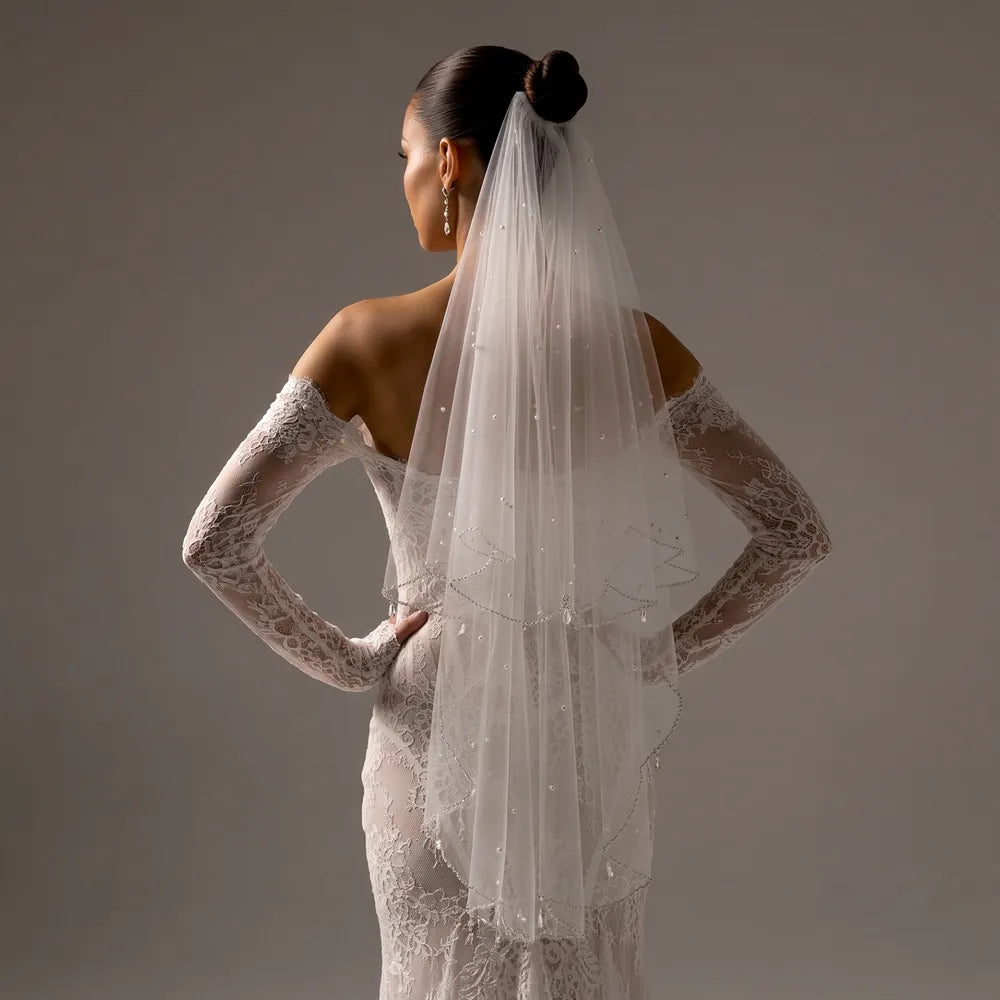 Close-up of overlapping tulle tiers demonstrating romantic depth created by double scalloped borders