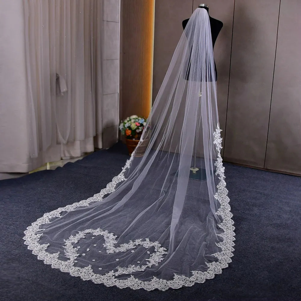 Overhead view capturing the 160cm wide cathedral veil fully fan-spread showing broad lace border