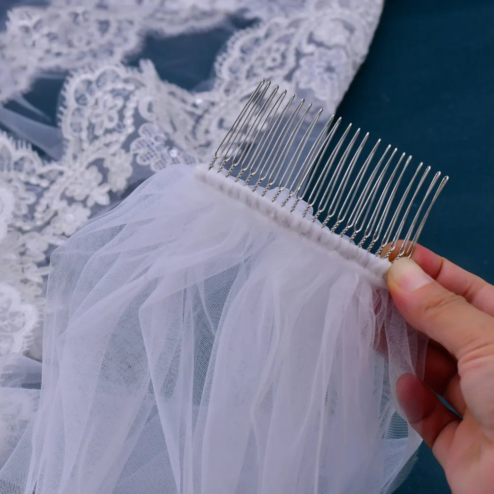 Close-up view of silver metal hair comb stitched to white gathered tulle for secure hold