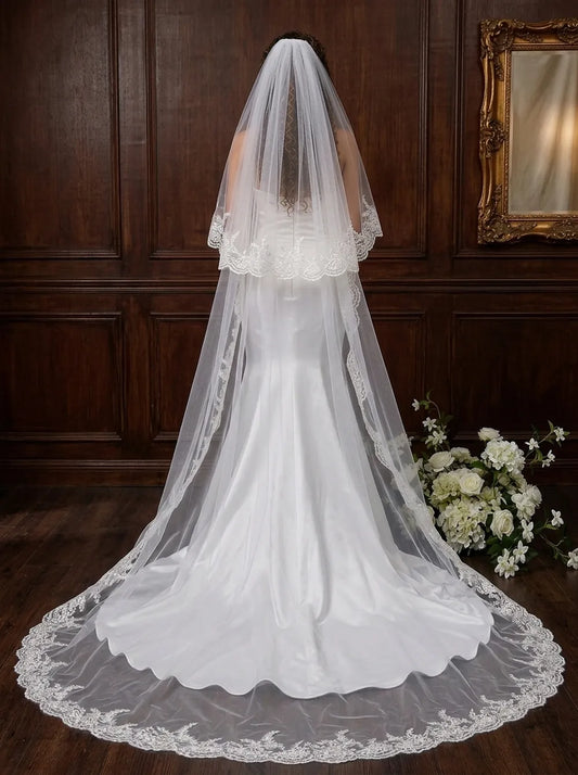 Two-tier lace cathedral wedding veil on mannequin showing 300cm train sweep and 80cm blusher layer