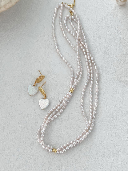 Full view of the three-strand necklace showing its 38 cm length and 5 cm extension chain for an adjustable fit.