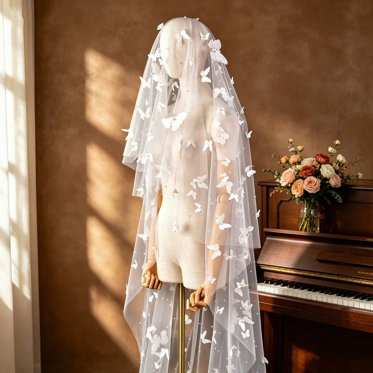 Three-quarter front view of 300cm 3D butterfly cathedral veil with blusher on dress mannequin in piano room