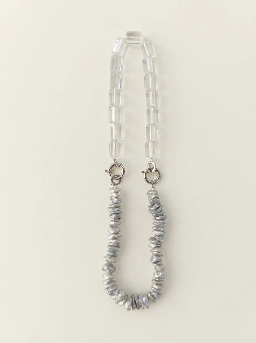 Full view flatlay of 40cm baroque pearl and clear quartz crystal necklace with S925 silver clasps.