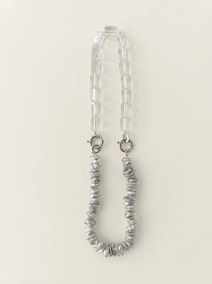 Full view flatlay of 40cm baroque pearl and clear quartz crystal necklace with S925 silver clasps.