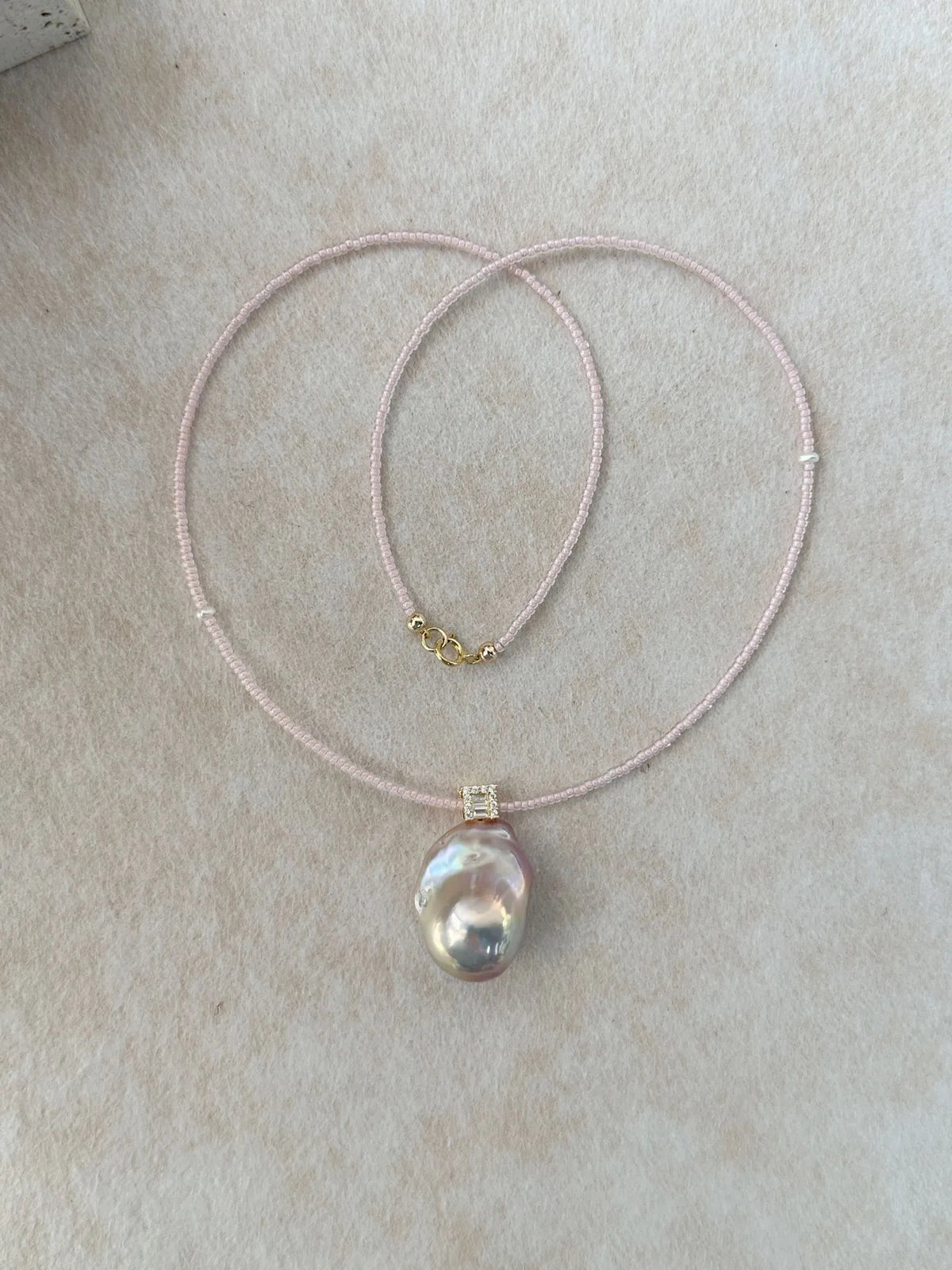 Flatlay display of the 42cm pink beaded baroque pearl necklace with 14K gold filled clasp.