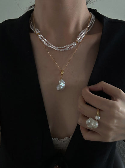 Close-up view highlighting the natural shapes and subtle luster of the freshwater pearls alongside the gold-plated details.