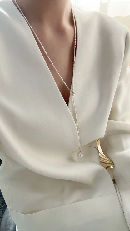 Side view of model displaying the drape of the 65cm adjustable Keshi pearl lariat.