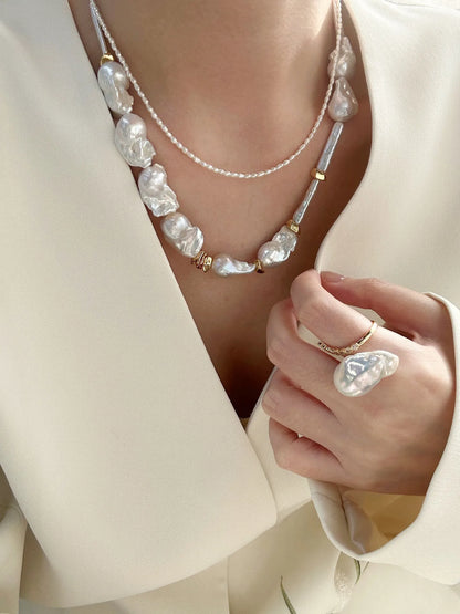 Rustic chic styling featuring the layered baroque pearl necklace set and matching pearl ring.