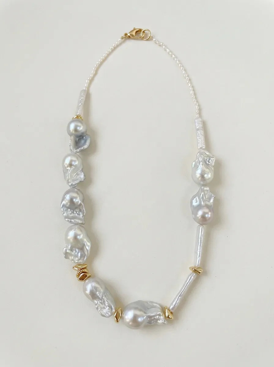 45cm barn-style baroque freshwater pearl necklace with brass gold accents and 18k gold plated clasp on white background.