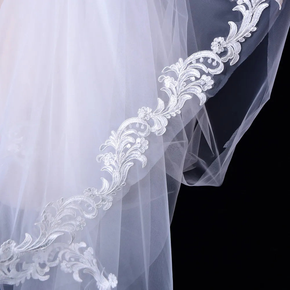 Close-up of scalloped embroidered baroque floral lace border trim on sheer tulle mesh