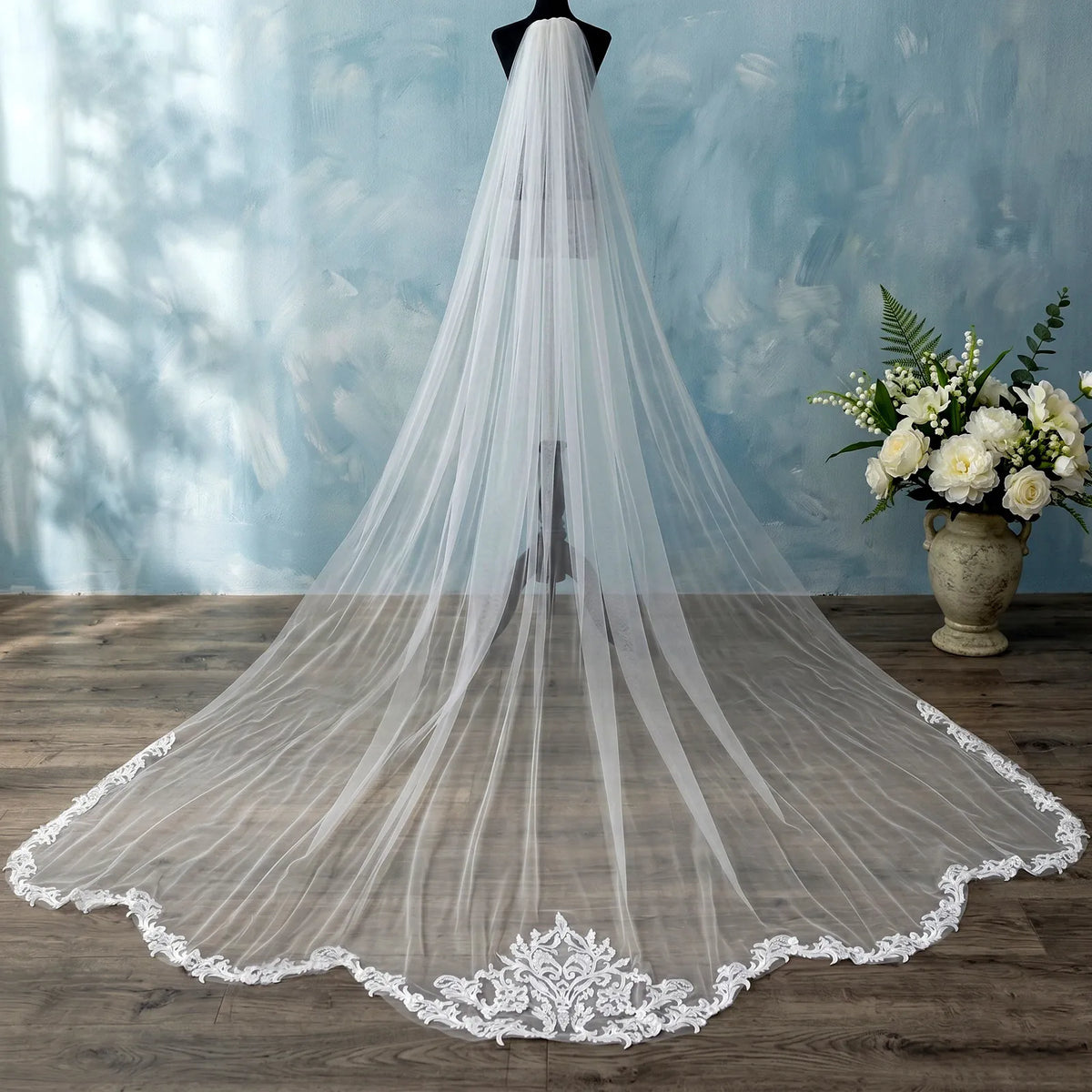Rear view of 350cm royal cathedral veil displaying baroque lace train border on black dress form mannequin