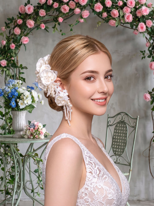 Baroque style luxury bridal headpiece set featuring a high-volume clustered pearl headband with satin silk roses and matching beaded tassel drop ear-pieces in creamy ivory.