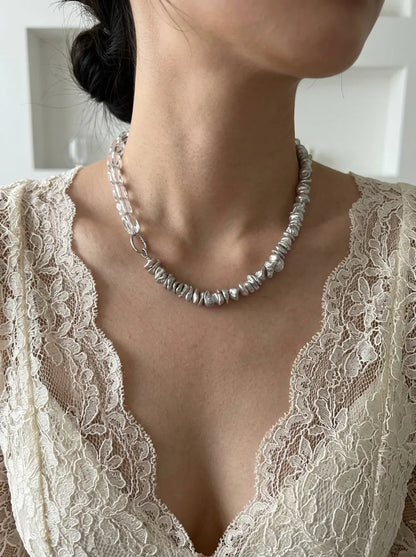Model wearing the asymmetrical baroque pearl and clear crystal choker with a lace dress.