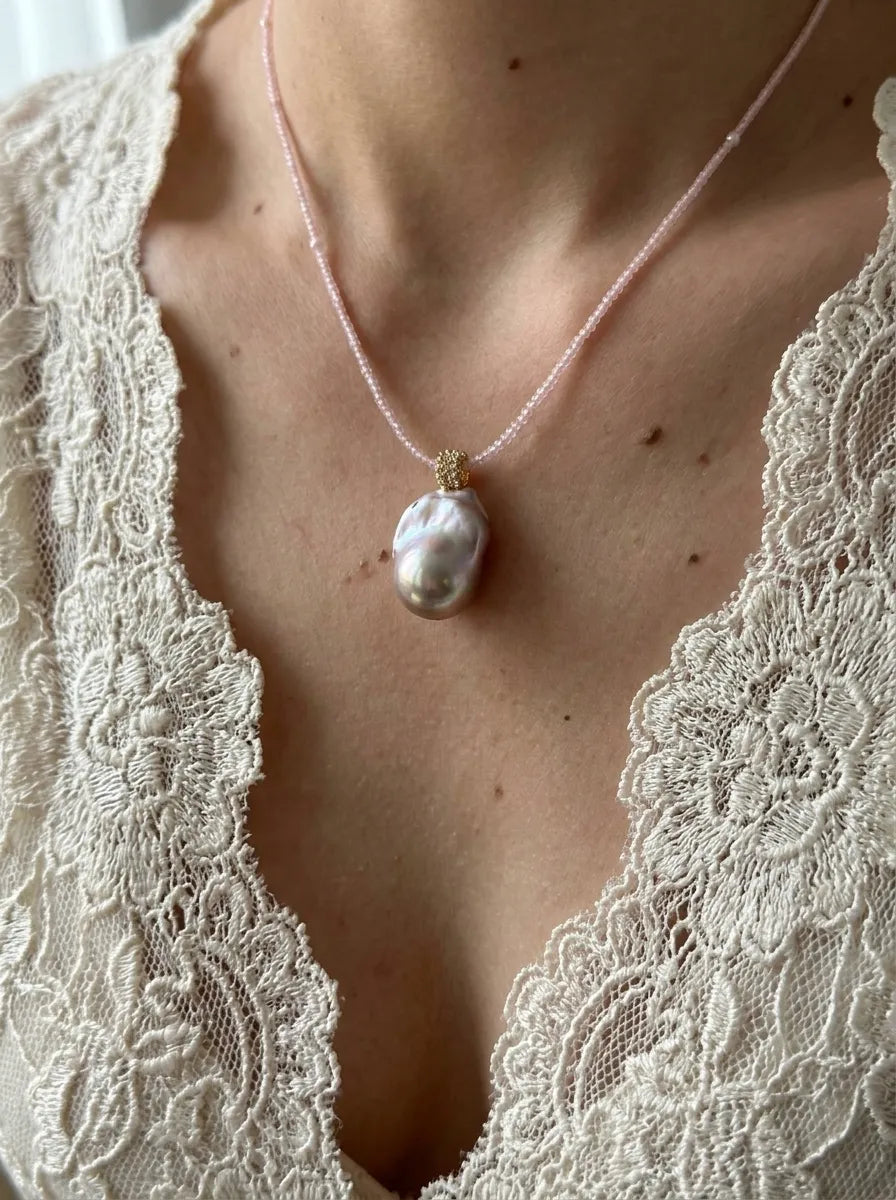 Model wearing the 42cm pink beaded baroque pearl necklace with a white lace v-neck top.