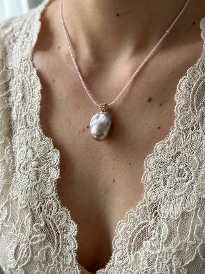 Model wearing the 42cm pink beaded baroque pearl necklace with a white lace v-neck top.