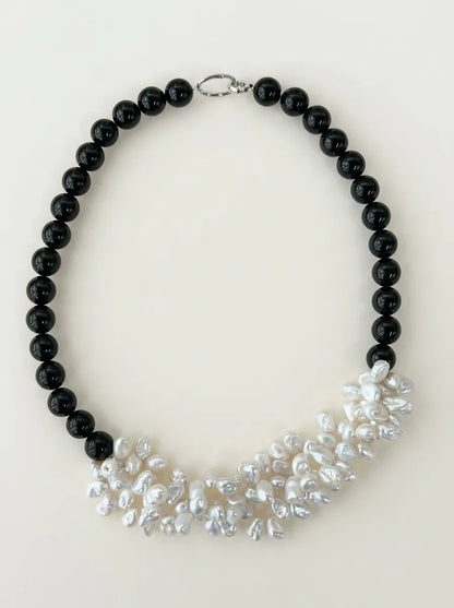 Full view flatlay of black agate and multi-layer white pearl cluster choker with S925 sterling silver clasp.