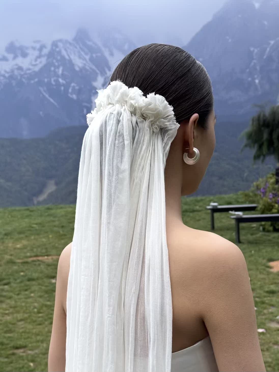floor-sweeping bridal veil with ruffled headbandpiece.