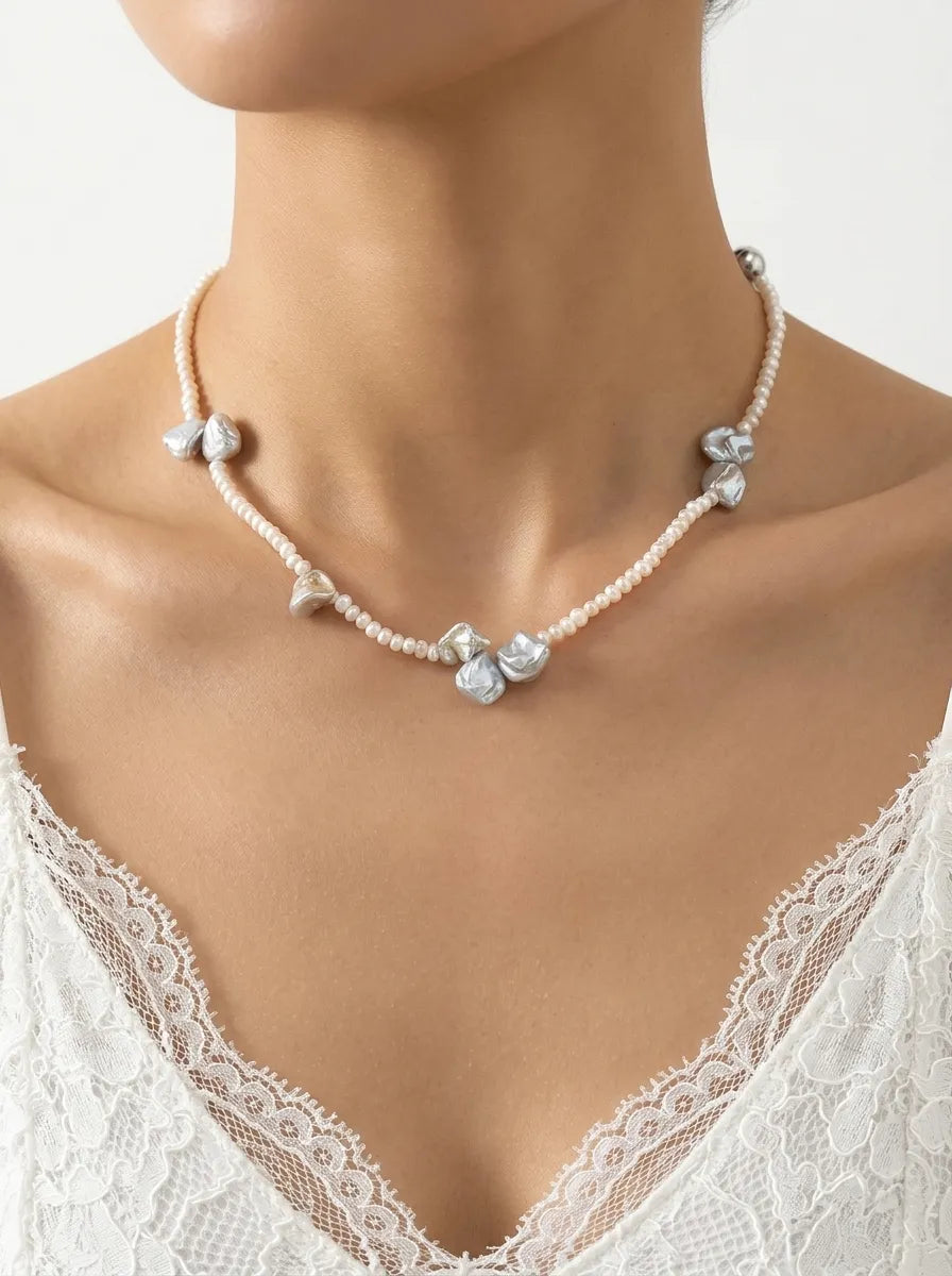 Model wearing organic petal freshwater pearl choker necklace paired with a lace bridal dress