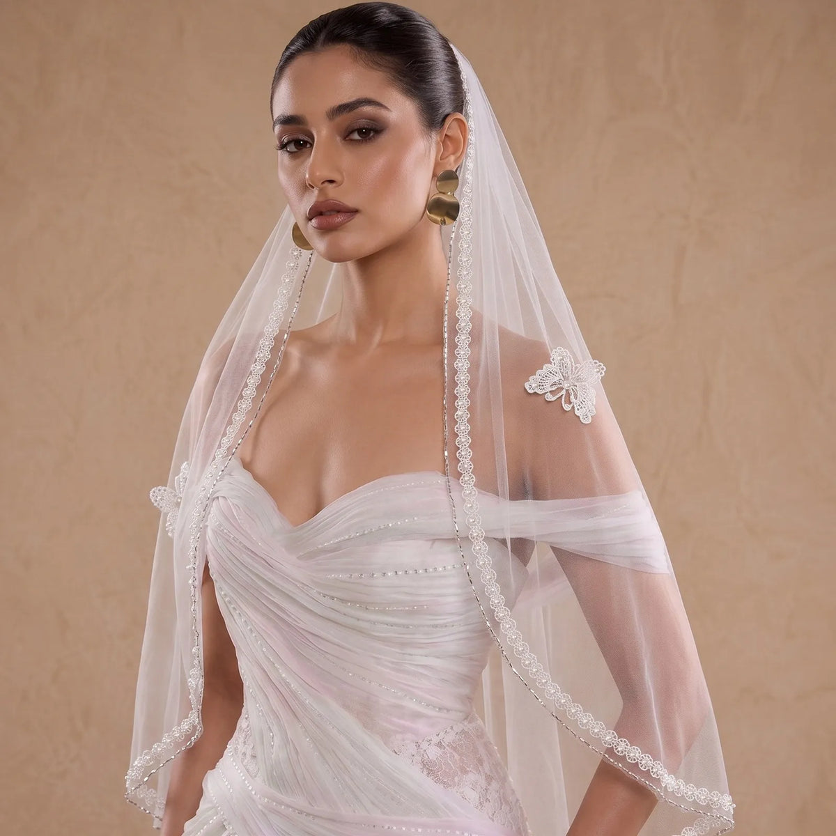 Close-up front view of veil draped over mannequin head, highlighting sheer soft mesh transparency and edge lace alignment