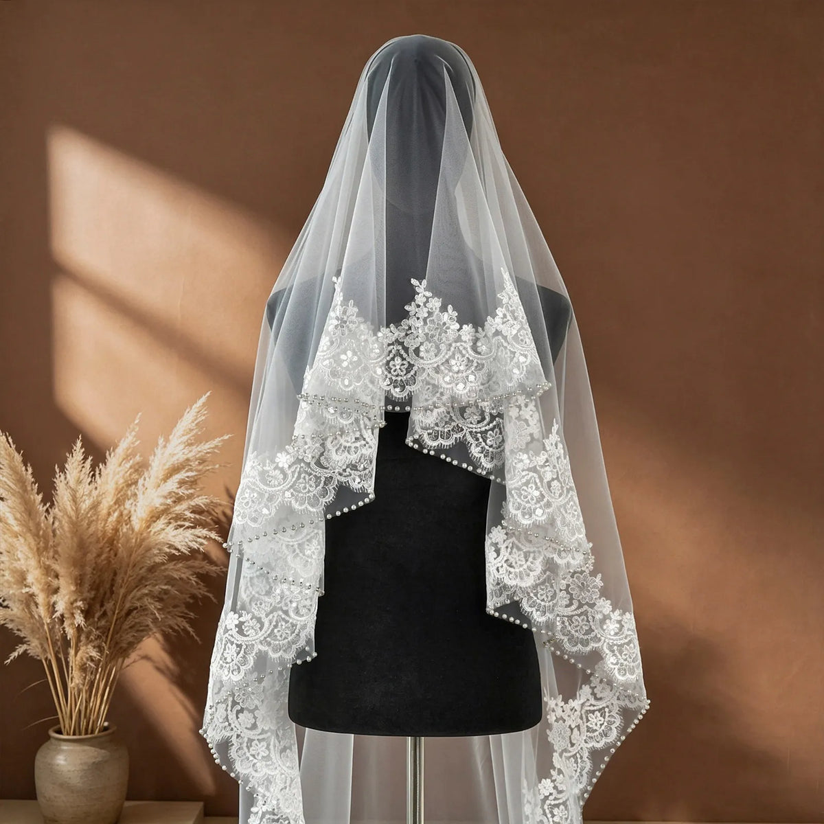 Elegant side view of bride standing with cathedral veil flowing smoothly down her gown, highlighting light reflection on sequins and pearls