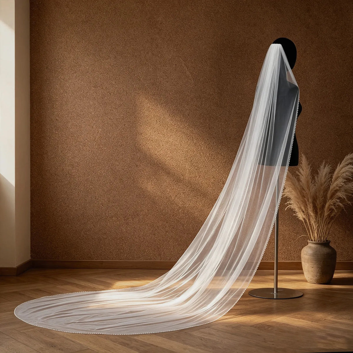 Close-up view of the veil's rounded trailing end spread on hardwood floor, showing shimmering sequin and pearl accent trim