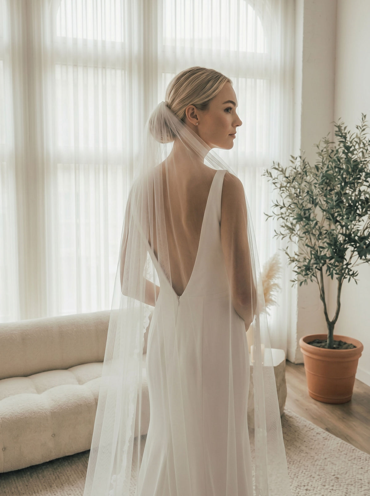 Back close-up of lightweight sheer tulle long wedding veil with delicate lace trim