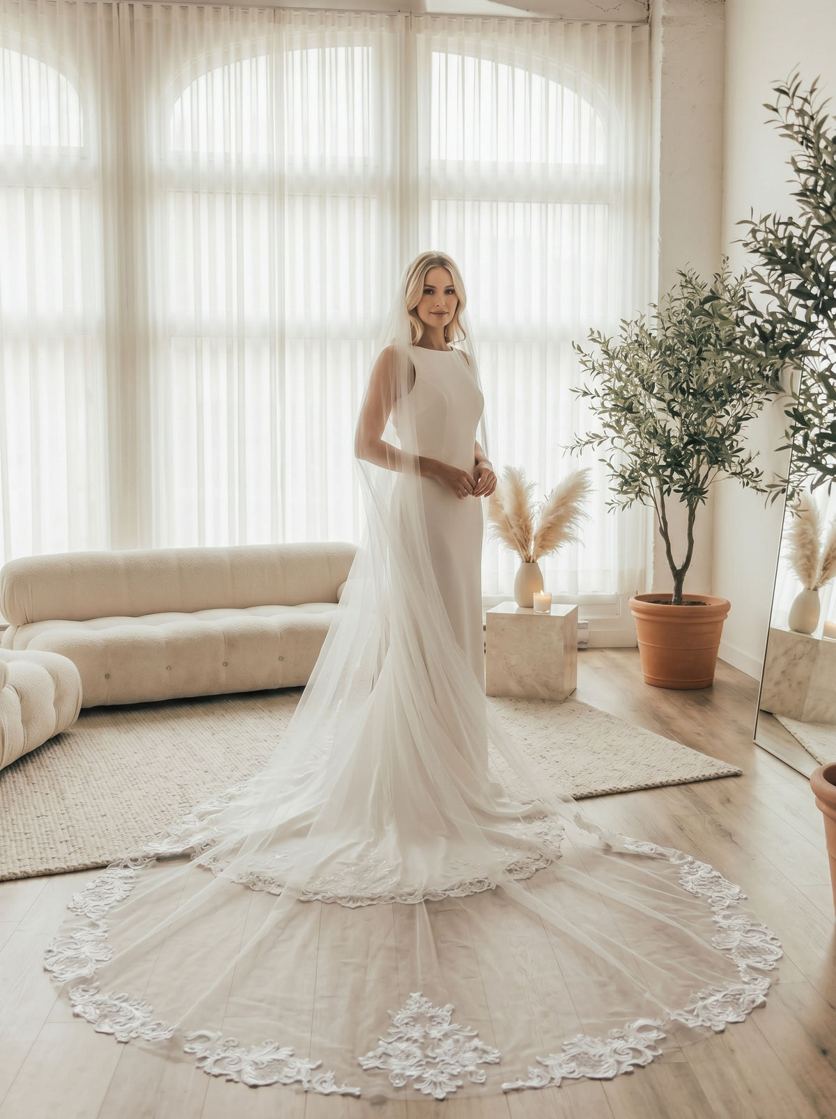 Bride wearing vintage lace border long trail sheer cathedral bridal wedding veil