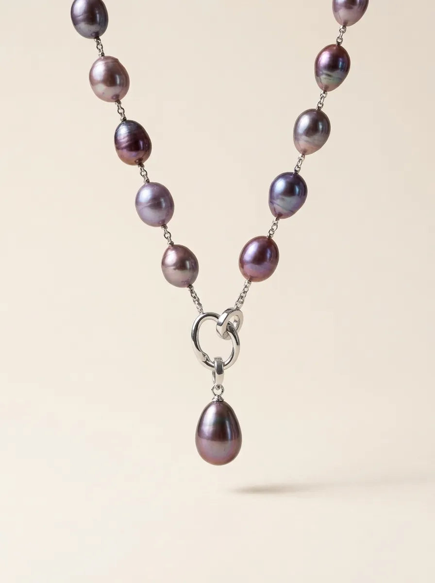 Floating studio shot of deep violet baroque pearl Y-lariat necklace highlighting S925 silver double-ring clasp and teardrop pearl pendant.