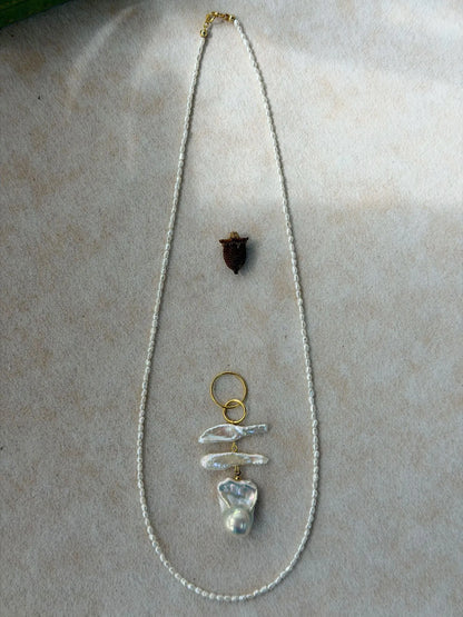 Detached freshwater seed pearl chain laid out with the separate baroque pearl pendant, showing the 2-in-1 convertible feature.