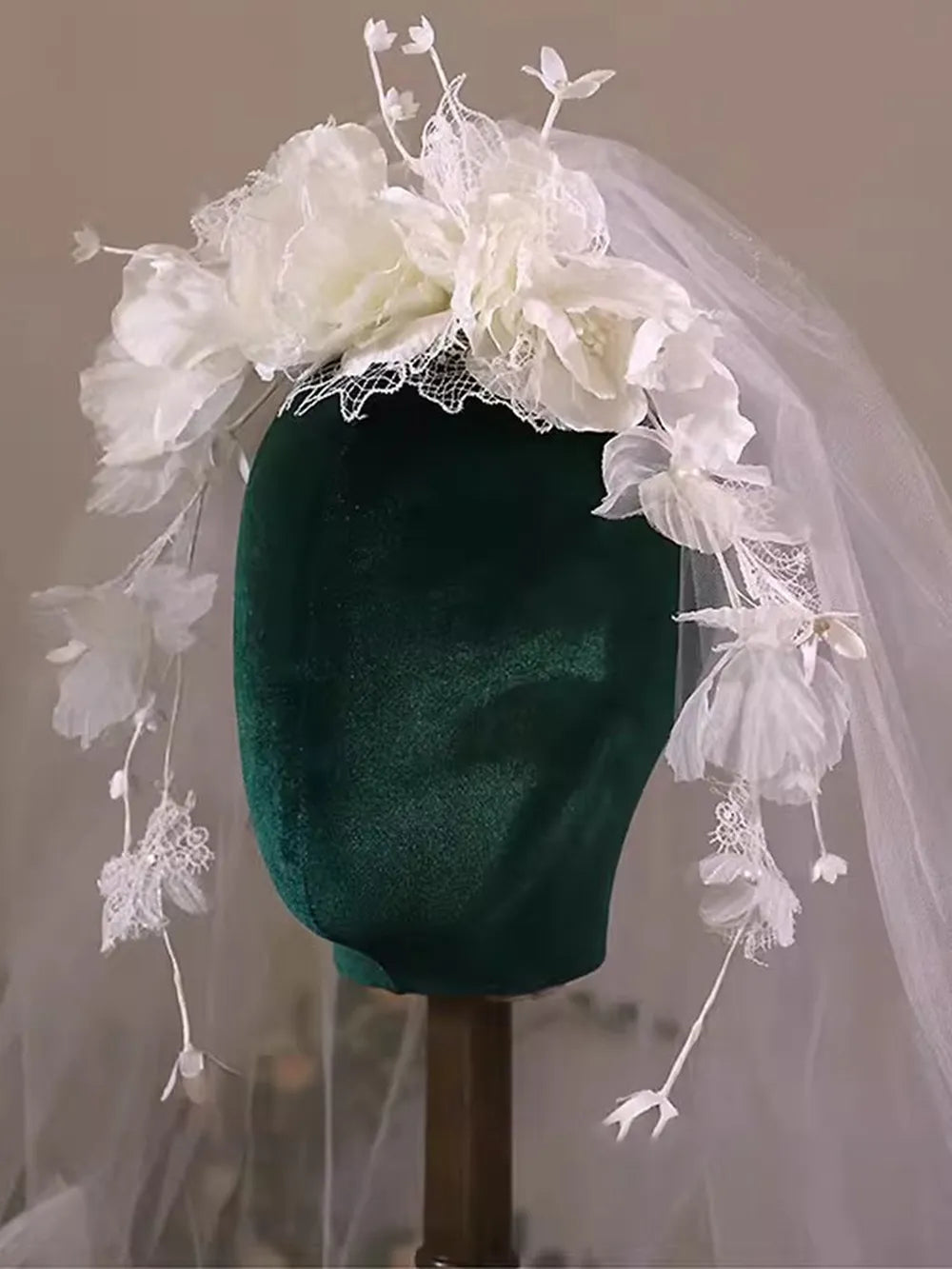 Soft sheer tulle wedding veil adorned with scattered floral petals and lace accents