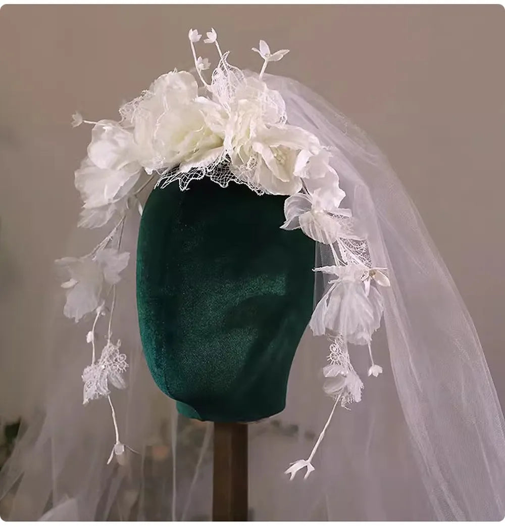 Soft sheer tulle wedding veil adorned with scattered floral petals and lace accents
