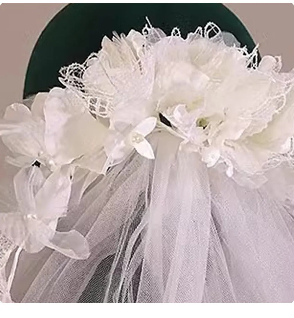 Close-up of hand-crafted fabric flowers and lace details on a bridal crown veil