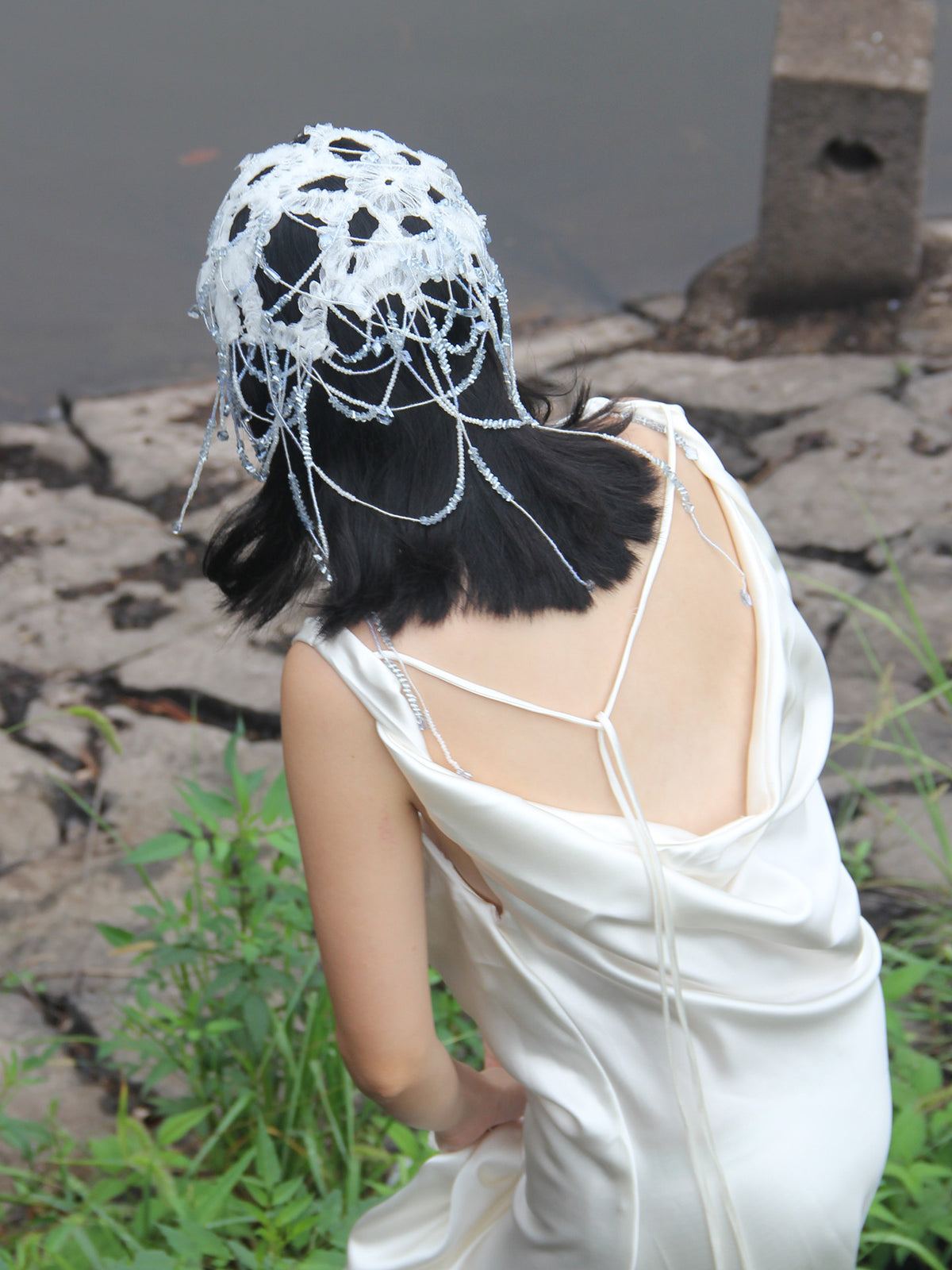 Fairy core bridal lace hair net and avant-garde Juliet cap featuring embroidered white floral lace, icy clear crystal beadwork, and layered cascading droplet strands.