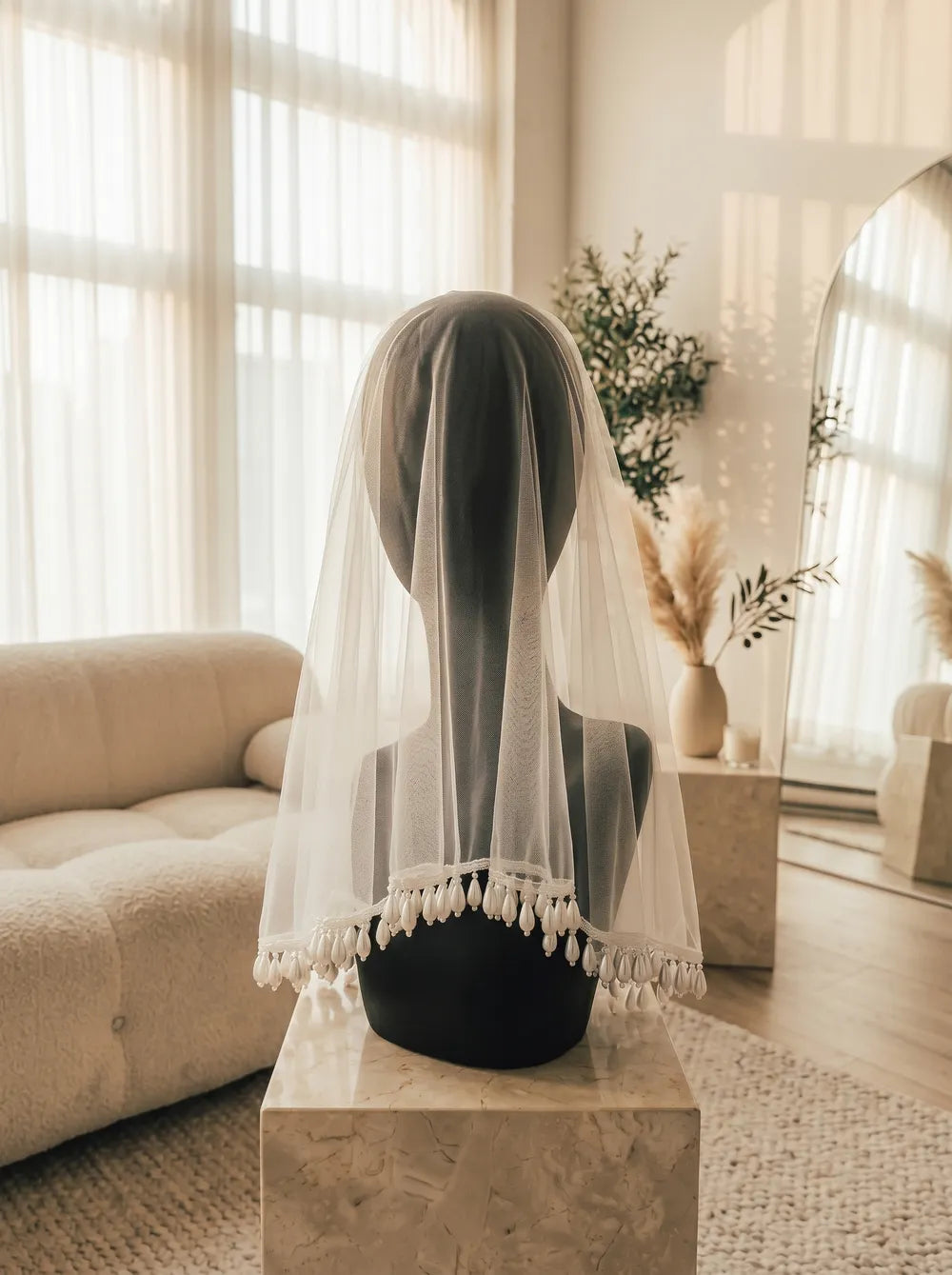 Side view showing natural fluid movement of dangling teardrop pearls along shoulder