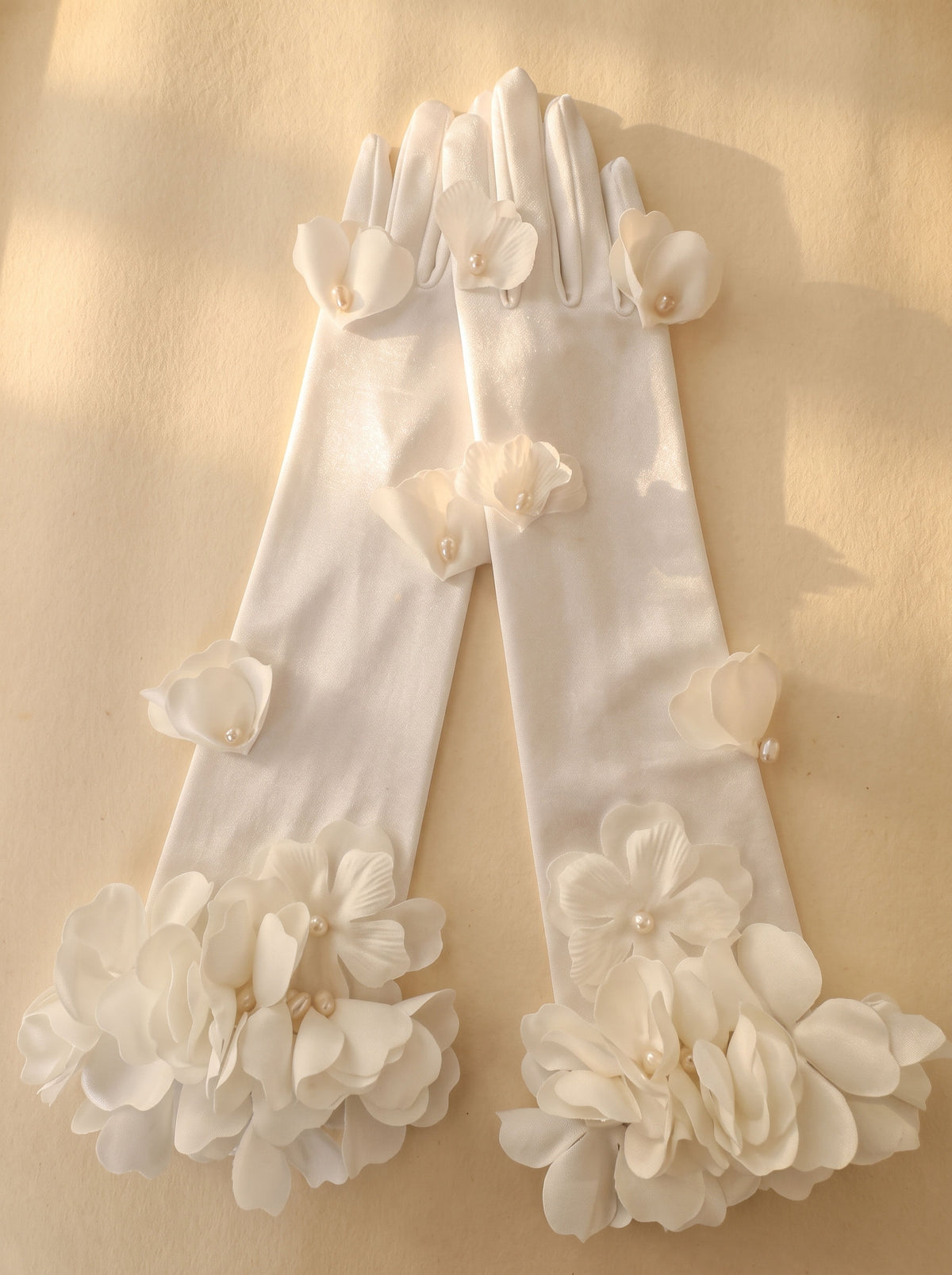 French romantic long ivory satin opera gloves with handcrafted 3D organza floral clusters and pearl petal embellishments for bridal wear.