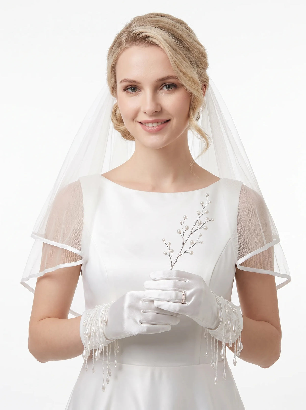 Close-up of elegant short white satin bridal wrist gloves detailed with delicate handcrafted pearl beads and cascading glass fringe strands.