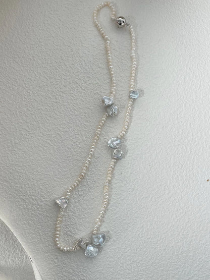 Full view of irregular petal freshwater pearl necklace showcasing the silver metallic magnetic clasp