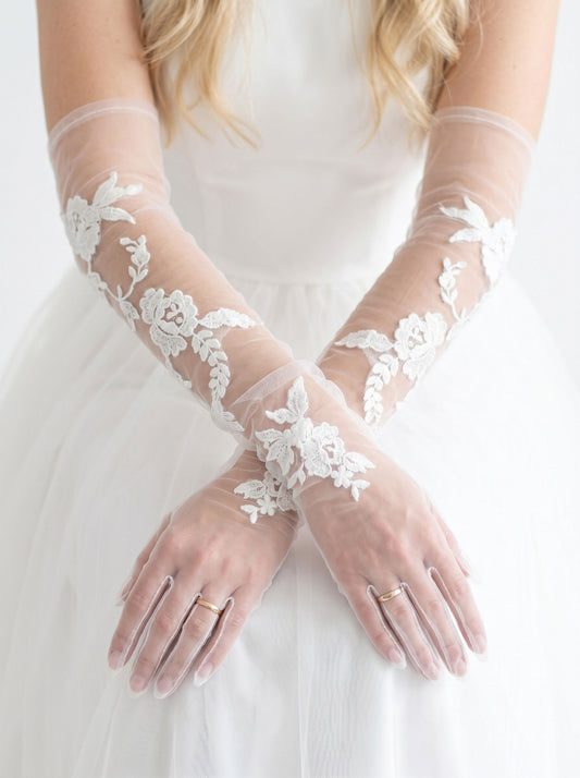 Dramatic 70cm off-white anti-wrinkle mesh bridal gloves with French ruched folds and floating botanical lace embroidery.