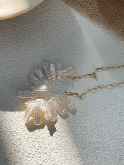 Close-up of naturally irregular freshwater pearls on a fine gold-filled chain