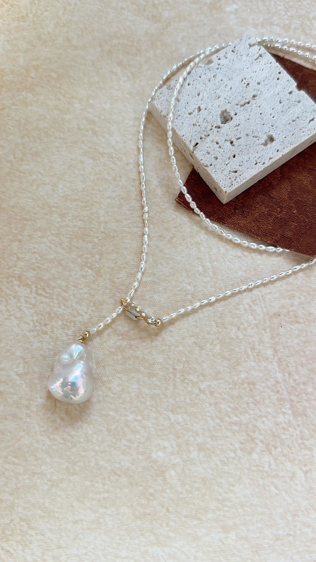 Close-up of the radiant luster and natural texture of the central Keshi baroque pearl drop