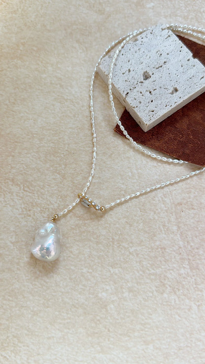 Close-up of the radiant luster and natural texture of the central Keshi baroque pearl drop