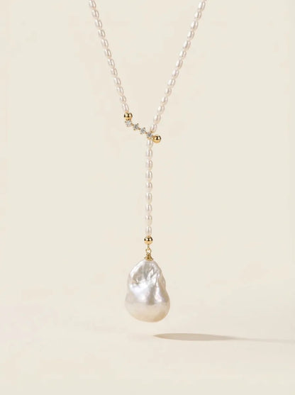 Studio shot showing the Keshi pearl pendant and 18K gold-plated CZ slider clasp details.