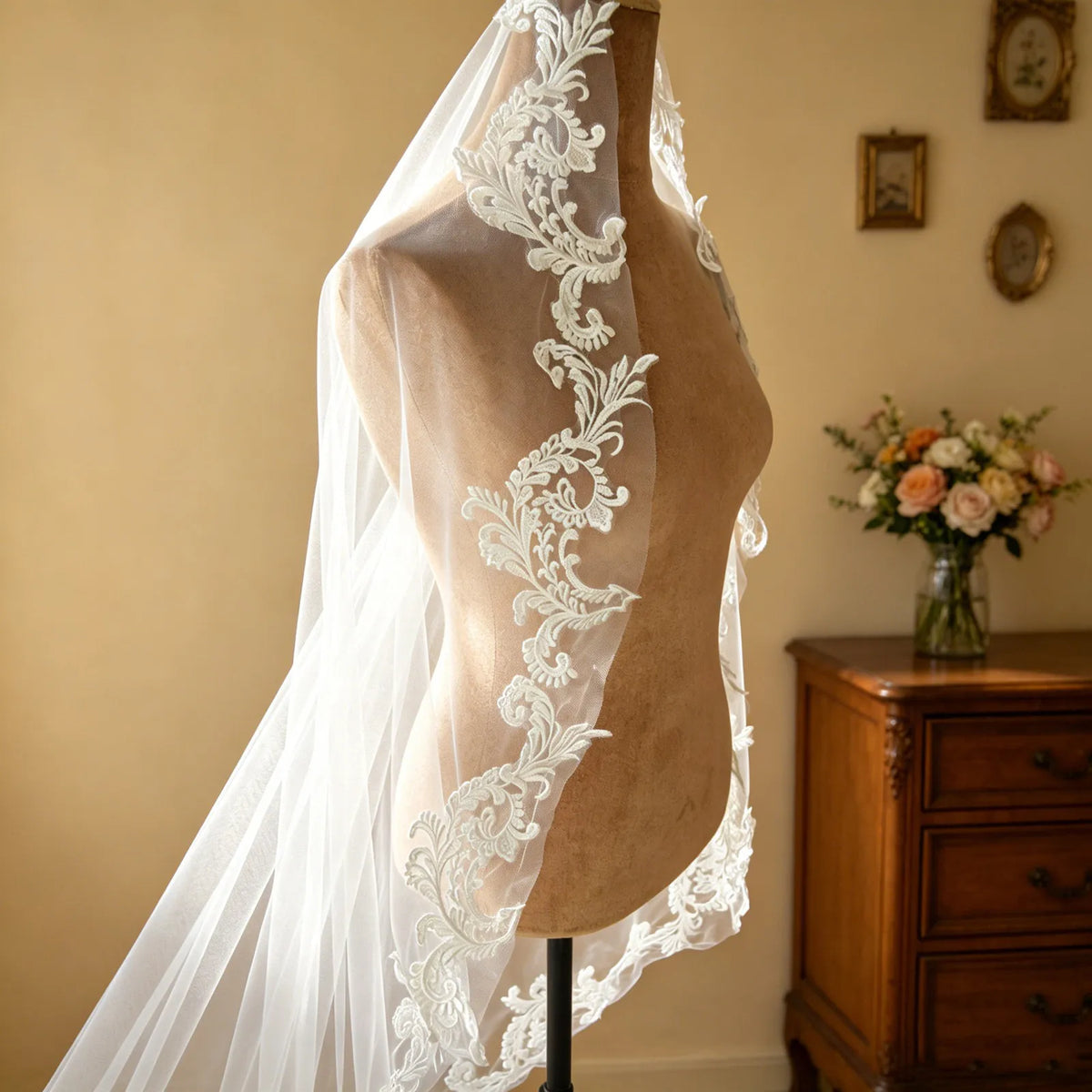 Side view of vintage mannequin showcasing delicate lace appliqué edging along sheer cathedral veil
