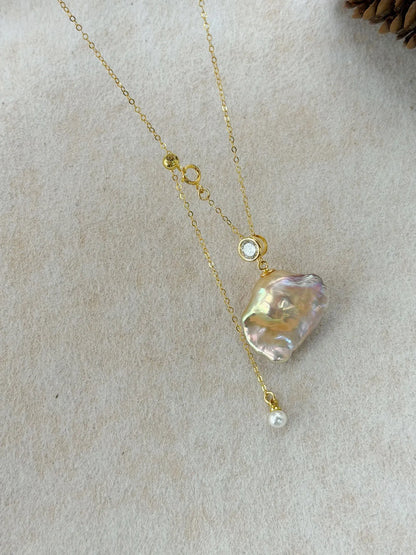 Close-up of large iridescent baroque pearl with 14K gold filled adjustable closure.