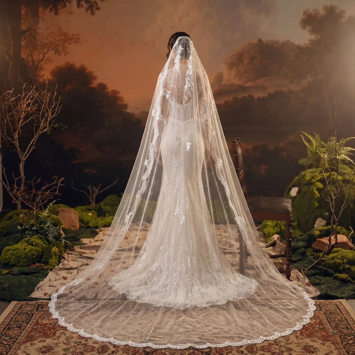 Full view of cathedral mantilla bridal veil with crown lace details cascading over a fitted mermaid wedding dress