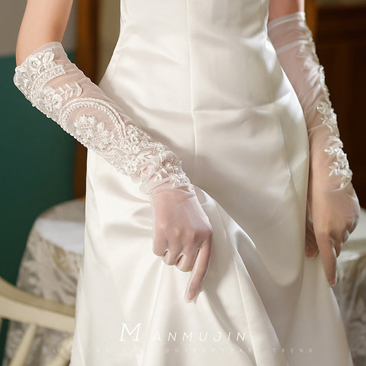 Ivory sheer tulle wedding gloves with embroidered lace appliqué and pearl details