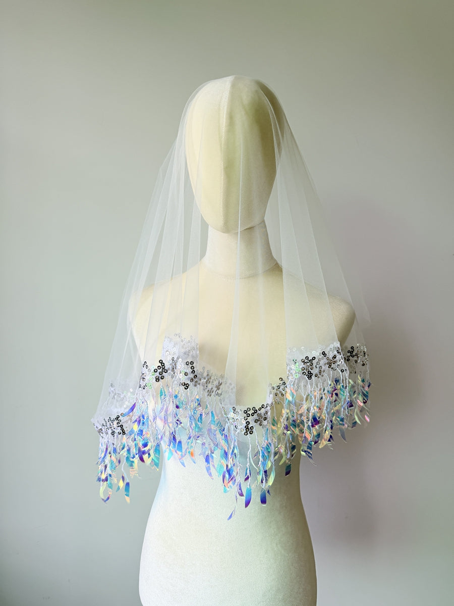 Close up of shimmering sequin tassel details on bridal veil